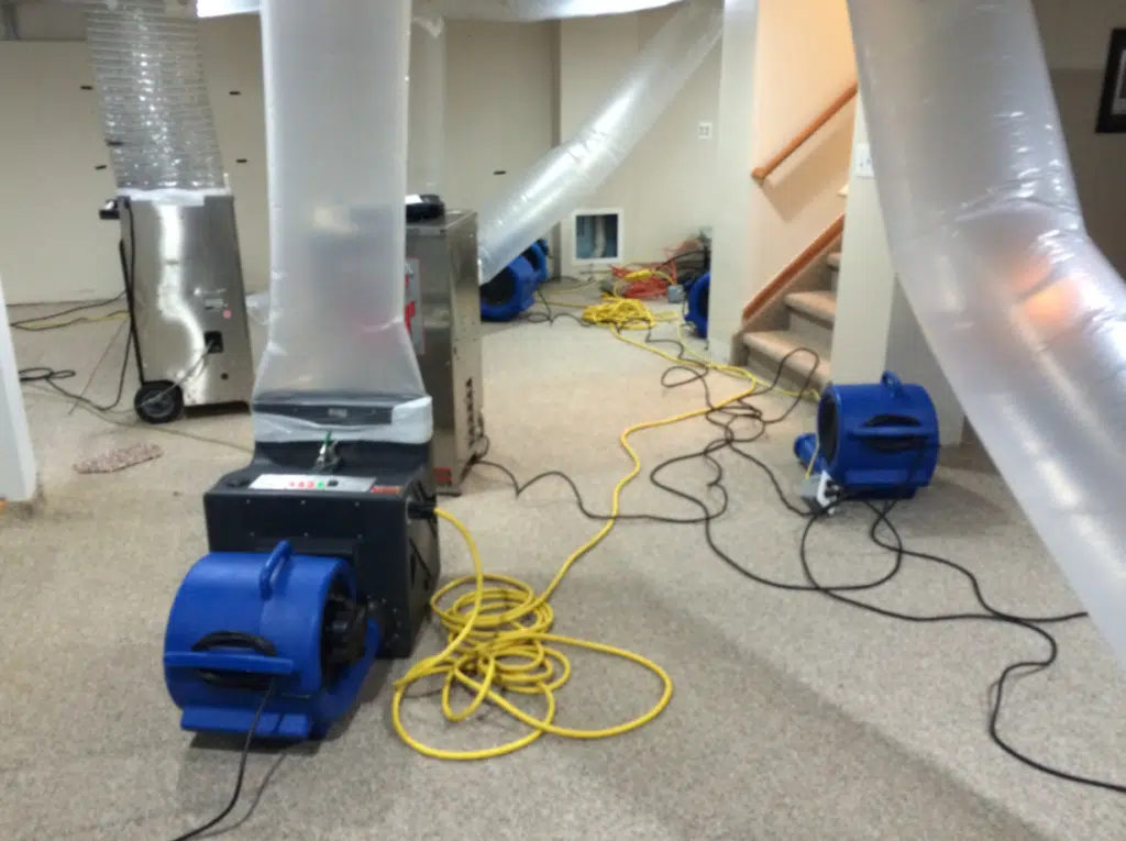 Drying equipment and plastic containment set up in a water-damaged room