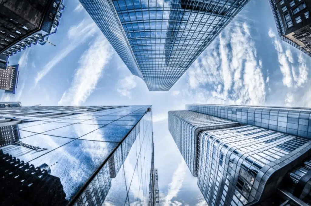 Looking up at glass high-rise office buildings