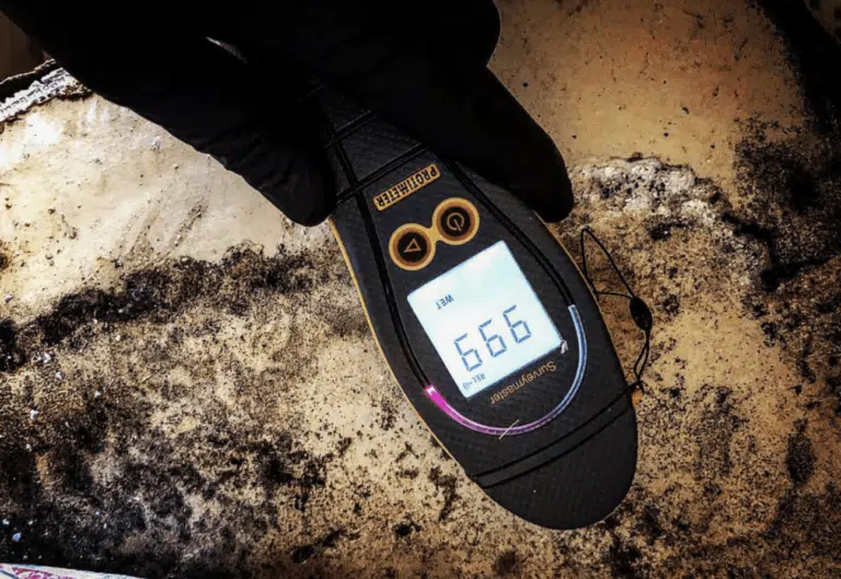 Moisture meter reading on a damaged floor